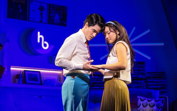 Two actors in an intimate moment on stage during "Maybe Happy Ending" performance.