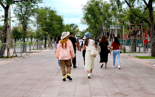 Visitors walking towards Wat Phra Kaew at the Grand Palace, Bangkok.