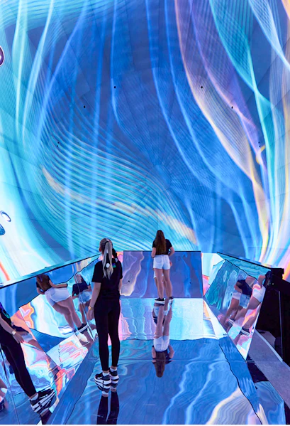 Visitors exploring immersive digital art installation in Budapest museum.