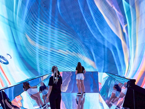 Visitors exploring immersive digital art installation in Budapest museum.