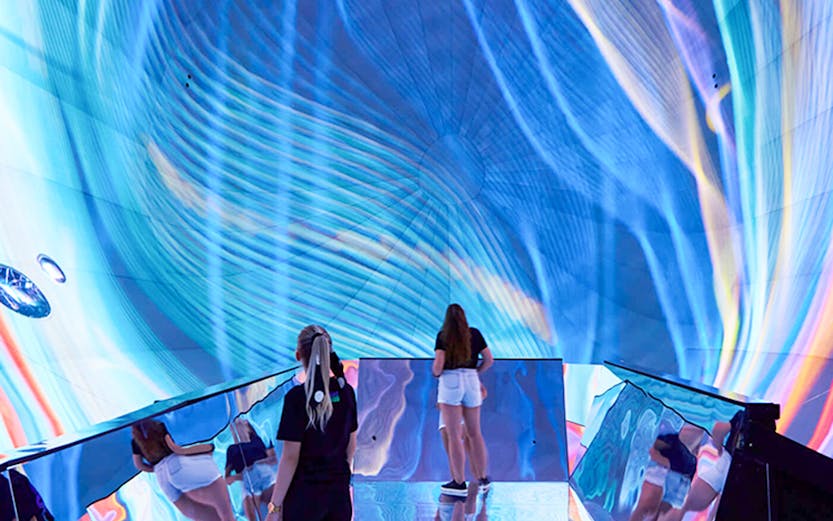 Visitors exploring immersive digital art installation in Budapest museum.