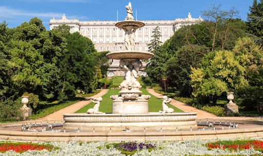 Royal Palace of Madrid exterior with tourists, part of Prado Museum and Royal Palace tour.