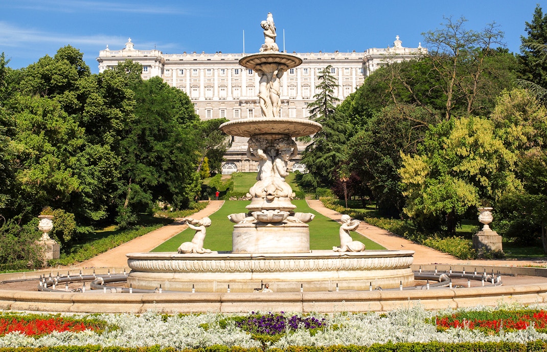 Royal Palace of Madrid exterior with tourists, part of Prado Museum and Royal Palace tour.