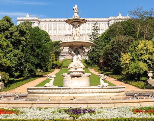 Royal Palace of Madrid exterior with tourists, part of Prado Museum and Royal Palace tour.