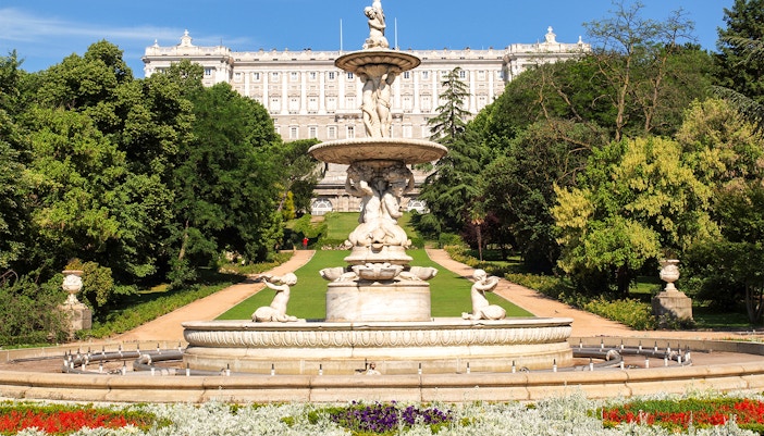 Royal Palace of Madrid exterior with tourists, part of Prado Museum and Royal Palace tour.
