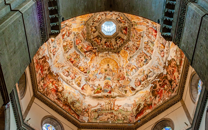 Frescoes inside Florence Duomo's dome during guided tour with cupola climb.