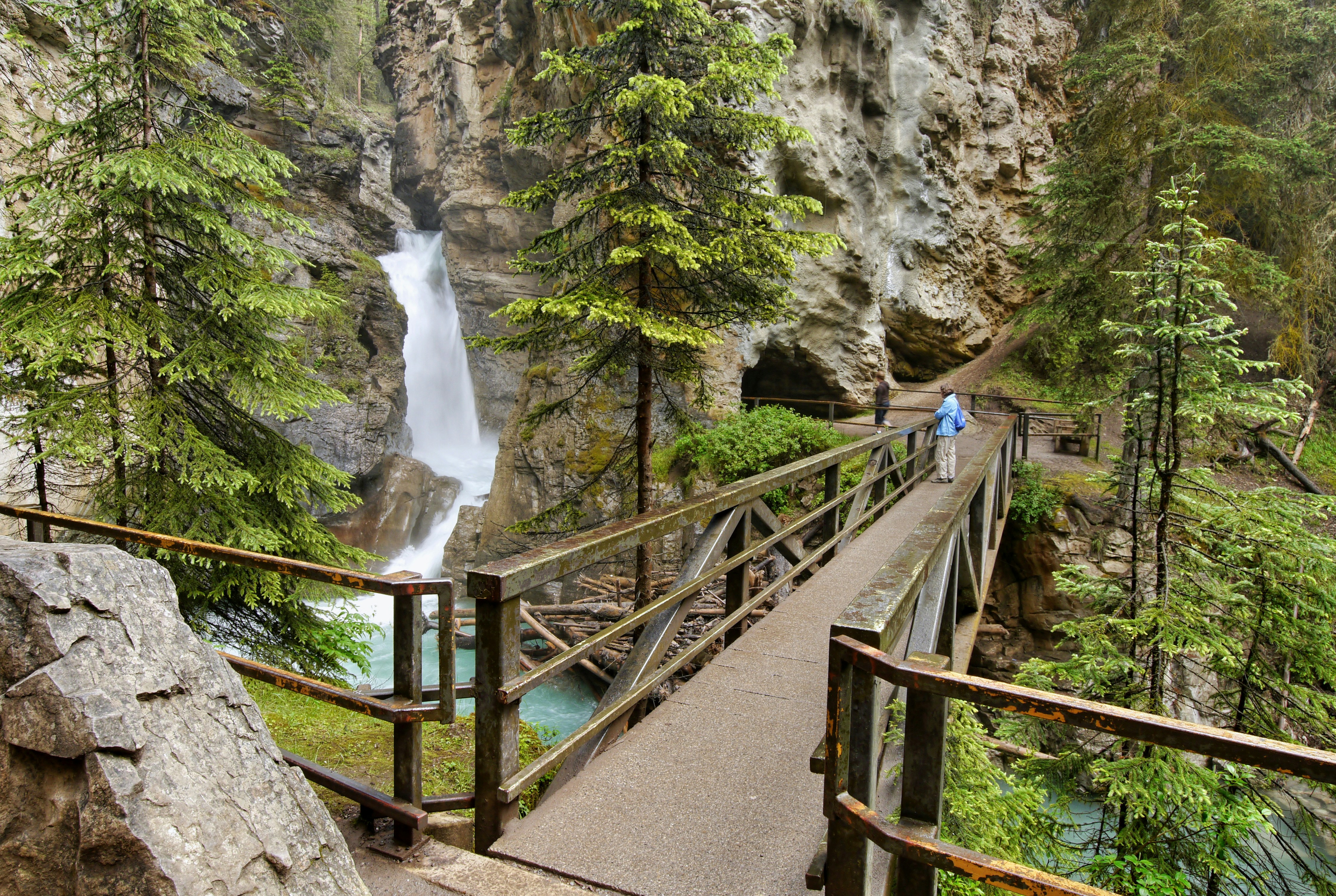 Bridge over Johnston Canyon with waterfall in Banff National Park, Canada.