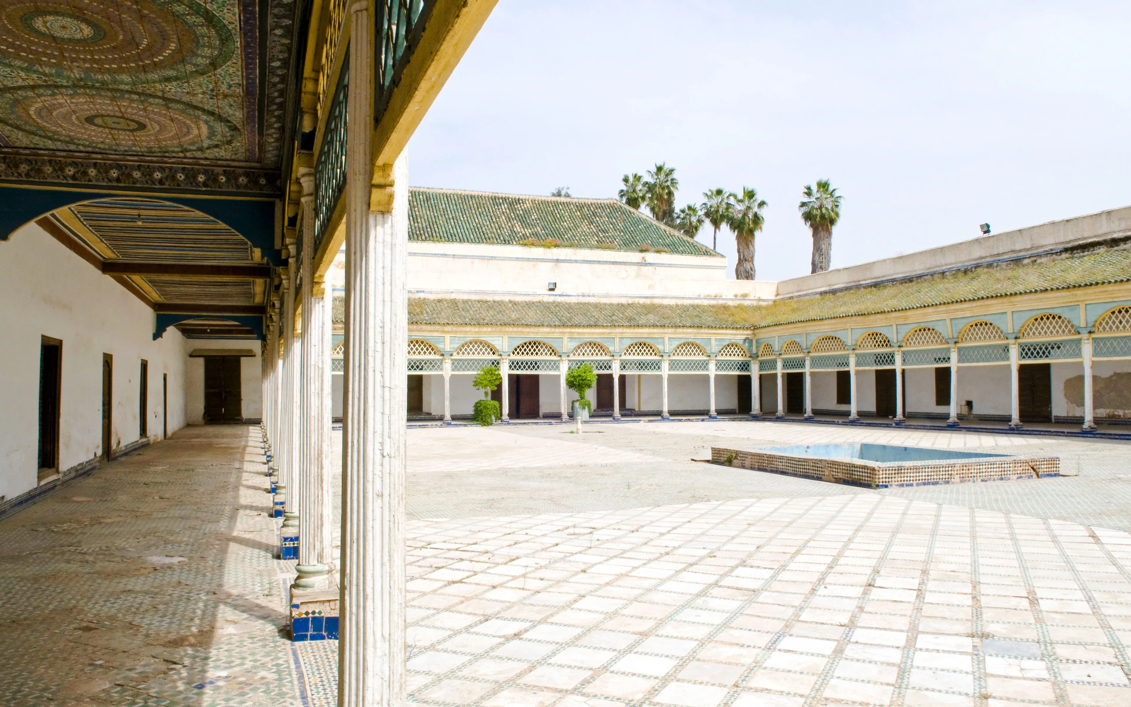 Bahia Palace courtyard with arched colonnade and tiled floor in Marrakech.