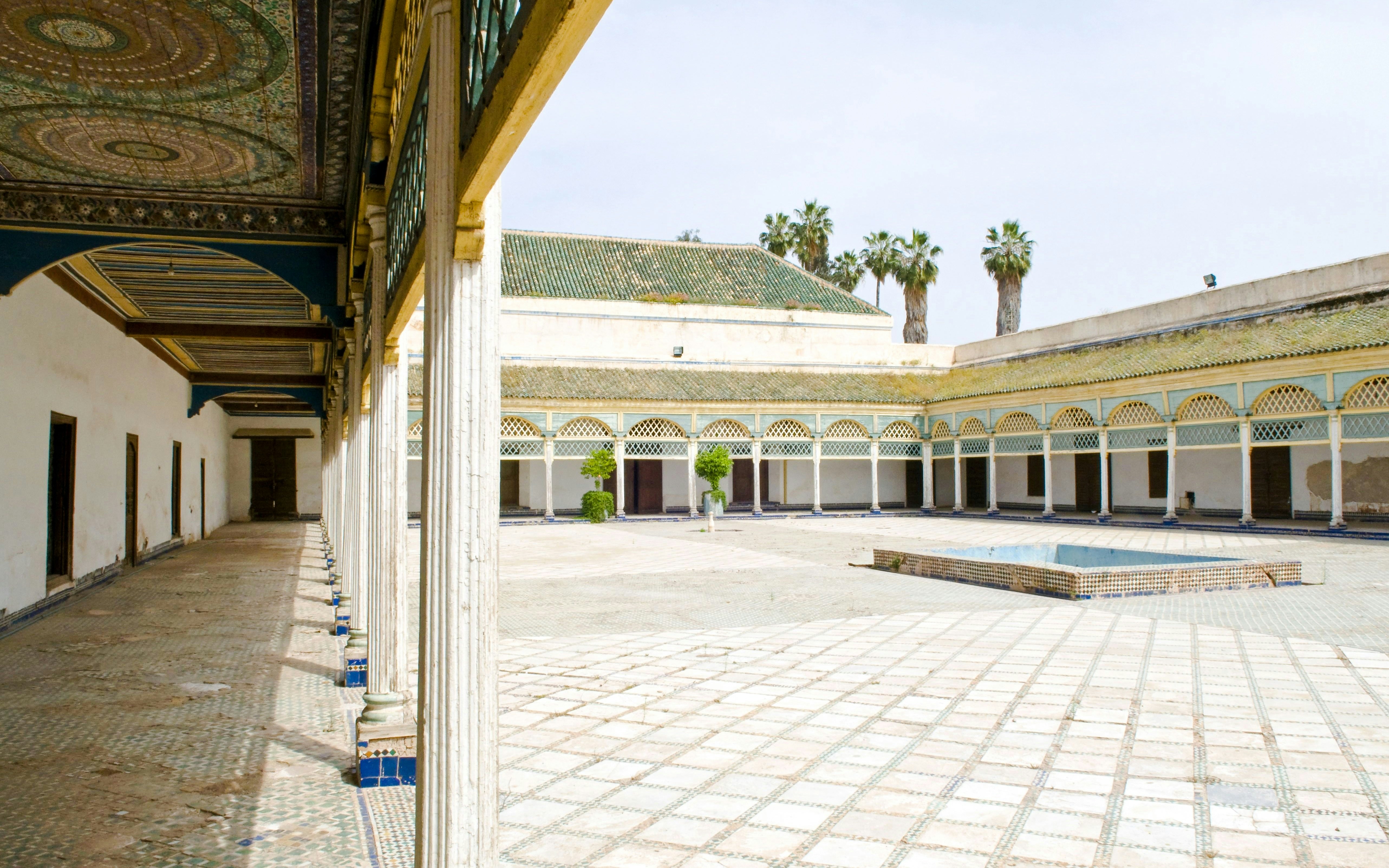Bahia Palace courtyard with arched colonnade and tiled floor in Marrakech.