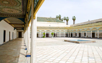 Bahia Palace courtyard with arched colonnade and tiled floor in Marrakech.