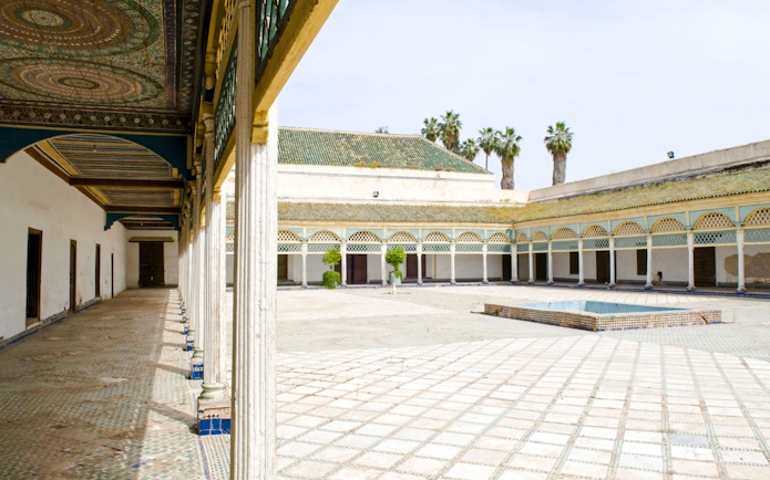Bahia Palace courtyard with arched colonnade and tiled floor in Marrakech.