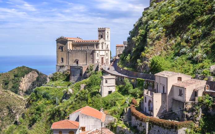 Saint Nicholas Church on a hilltop in Savoca, Sicily, overlooking the sea.