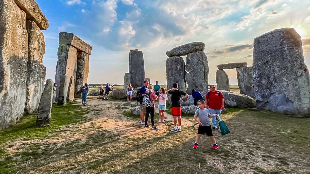 Visitors walking among Stonehenge stones during exclusive tour from London.