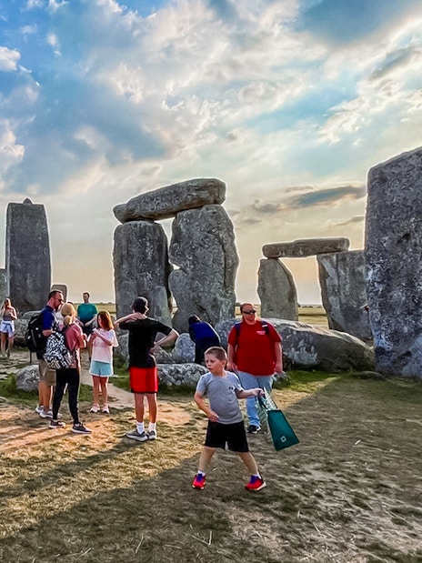 Visitors walking among Stonehenge stones during exclusive tour from London.
