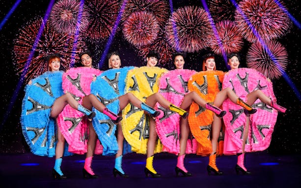 Paradis Latin cabaret show in Paris with performers on stage.