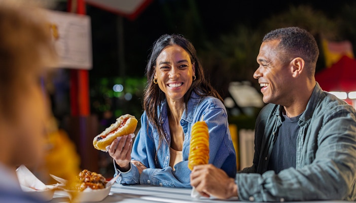 Dreamworld Gold Coast night market with vibrant stalls and visitors exploring local crafts and street food.