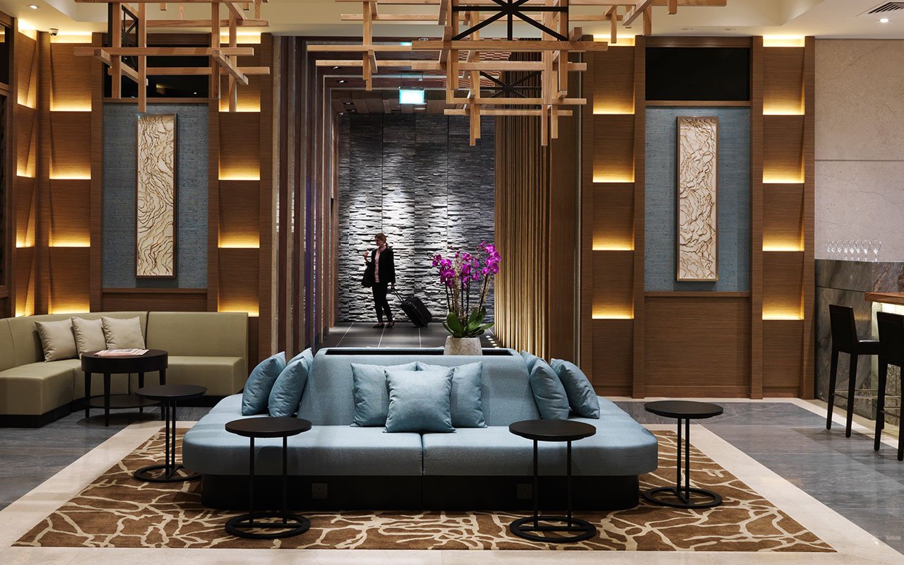 Traveller entering Plaza Premium Lounge, Terminal 2, London Heathrow Airport.