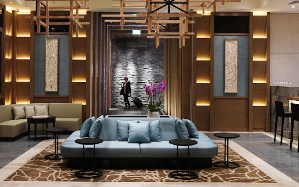 Traveller entering Plaza Premium Lounge, Terminal 2, London Heathrow Airport.