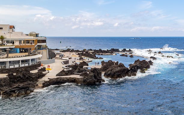 Cabo Girão and Porto Moniz lava pools with visitors enjoying the ocean view.