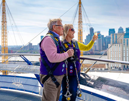 Guests enjoying drinks on the Up at the O2 Celebration Climb with city skyline views.