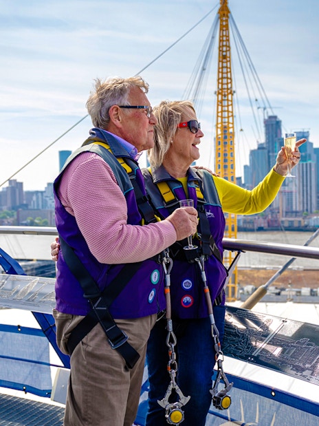 Guests enjoying drinks on the Up at the O2 Celebration Climb with city skyline views.