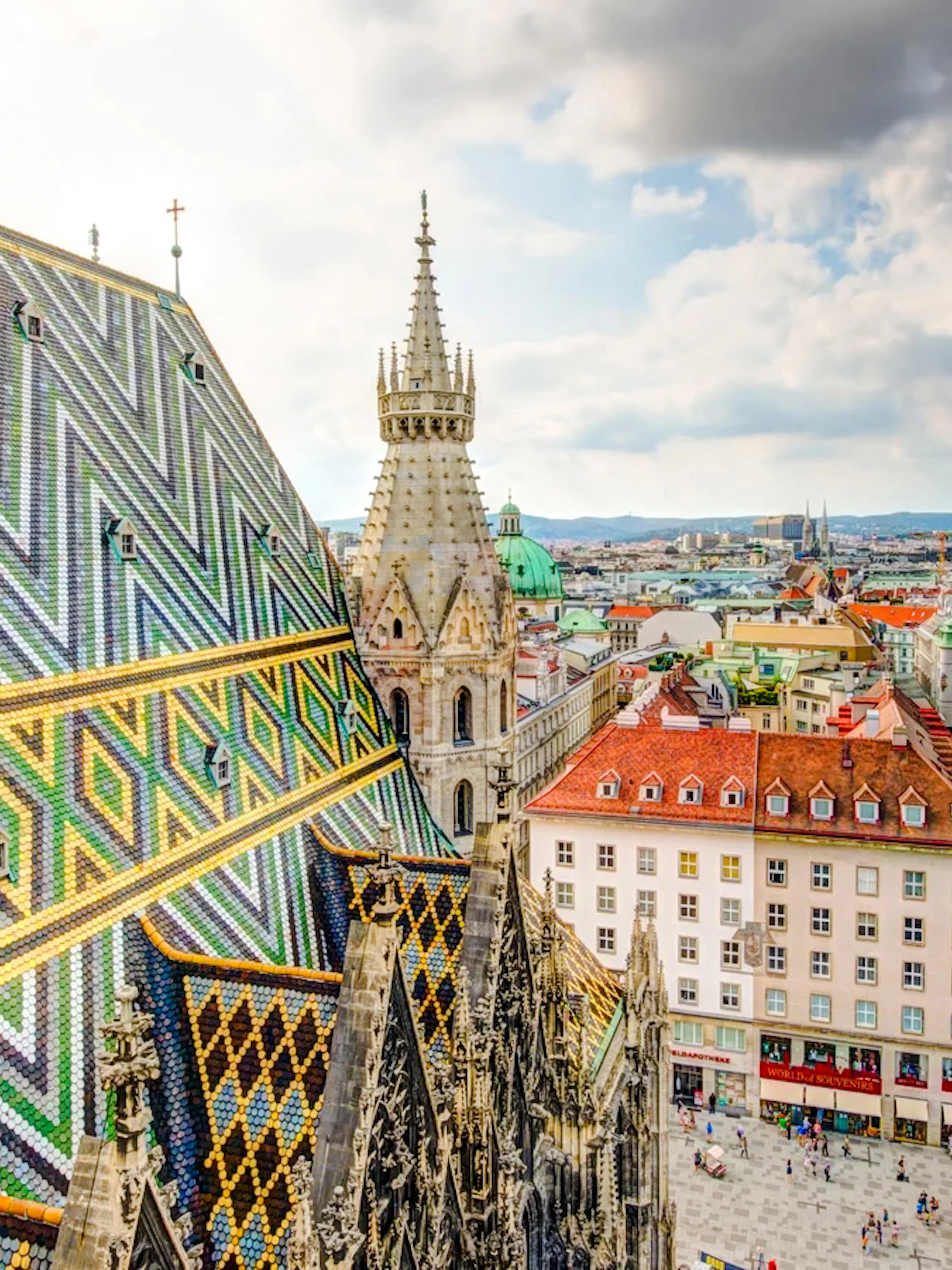 St. Stephen's Cathedral rooftop view in Vienna, featuring colorful patterned tiles and cityscape.
