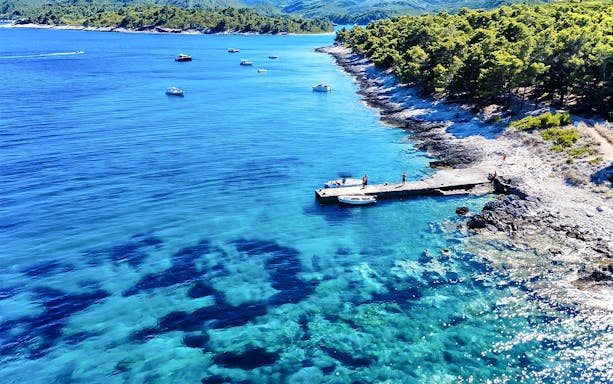 Snorkeling and swimming at a secluded beach in Korčula, Dubrovnik with clear blue waters.