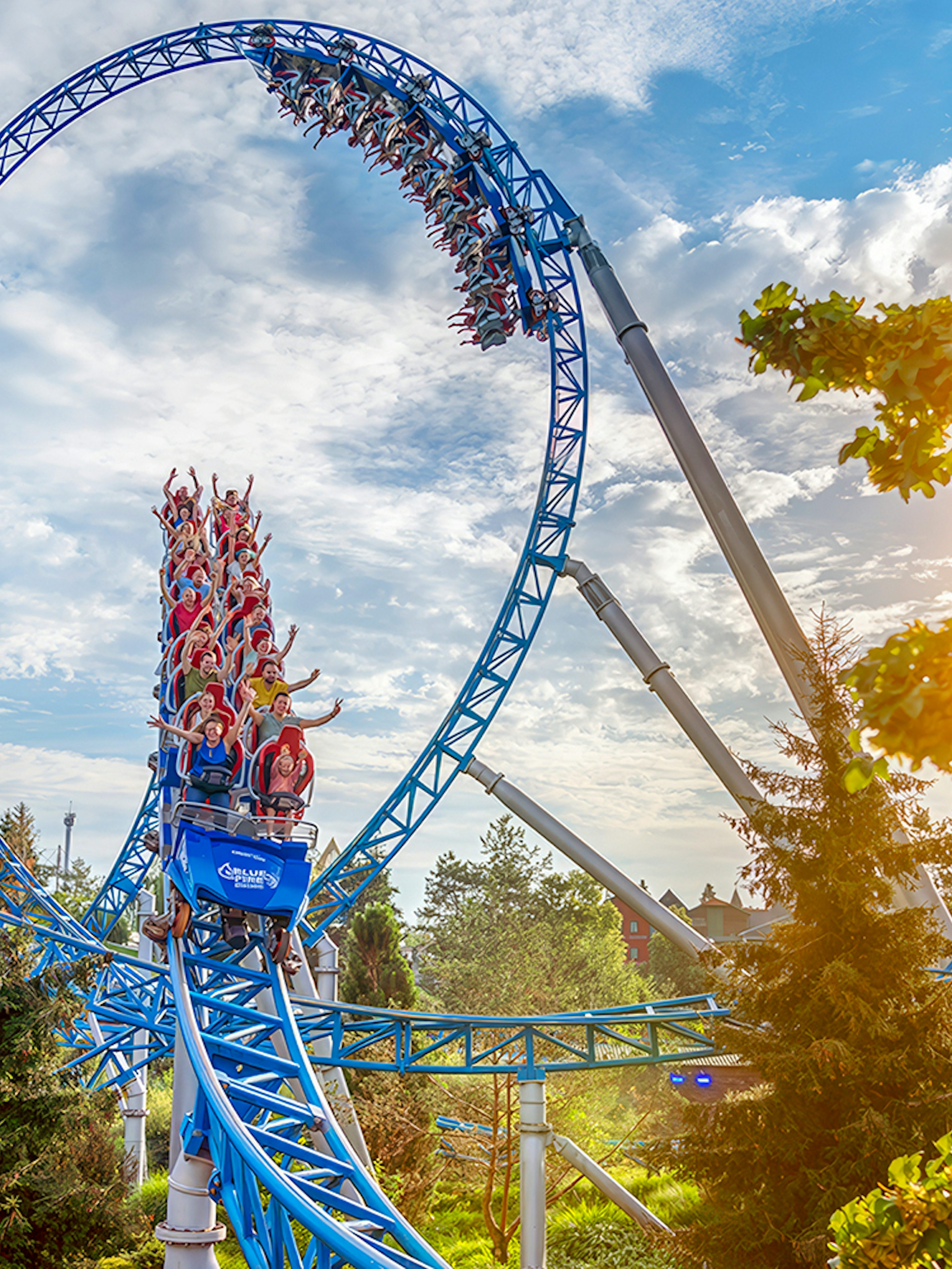 Roller coaster loop with riders at Europa-Park under a sunny sky.