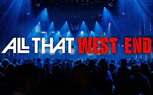 Crowd enjoying a vibrant night event with "All That West End" signage.