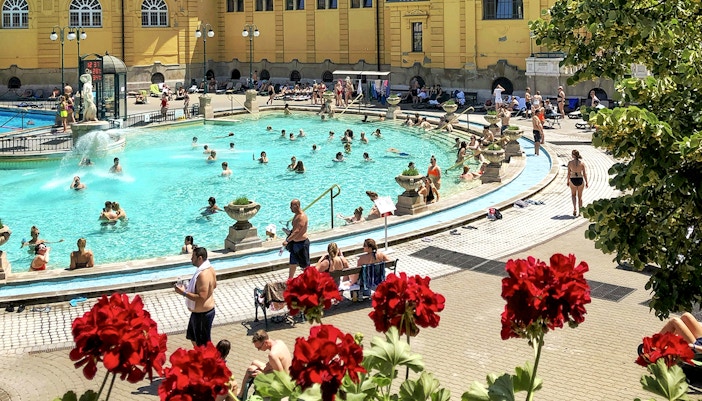 Guests relaxing in thermal pools at Széchenyi Spa, Budapest.