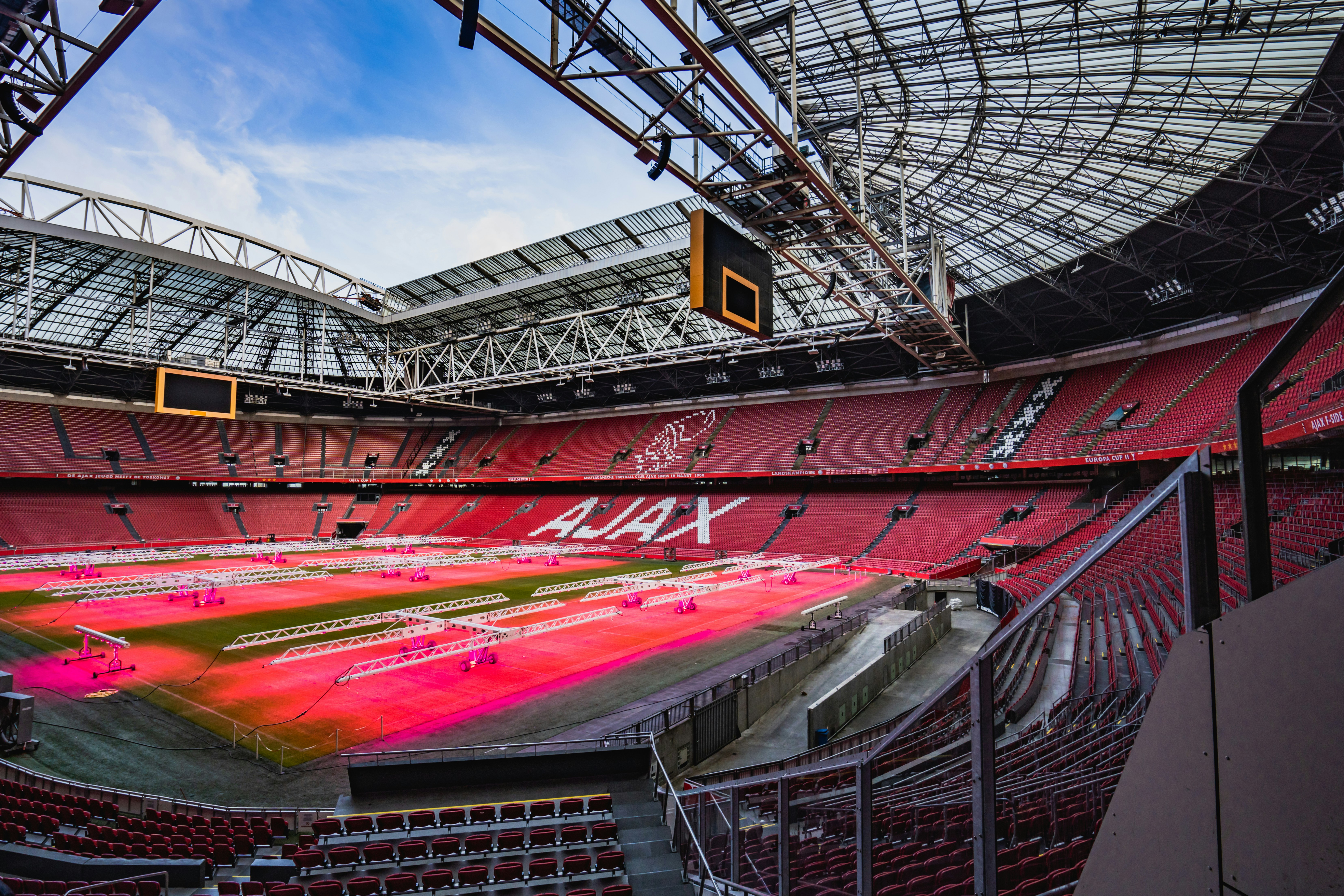 Johan Cruijff ArenA stadium interior with empty seats and field in Amsterdam.