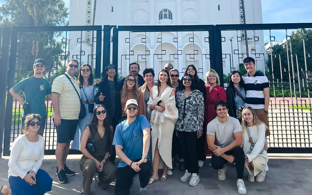 Group of tourists in front of a historic building gate during a Casablanca tour.