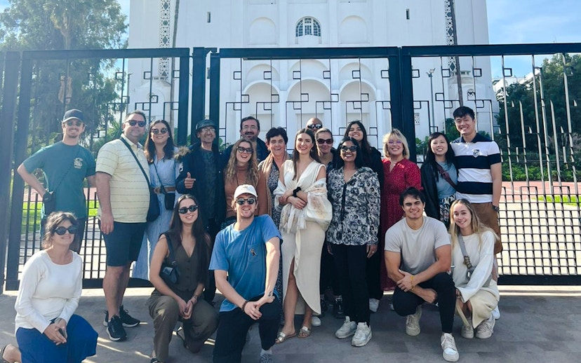 Group of tourists in front of a historic building gate during a Casablanca tour.