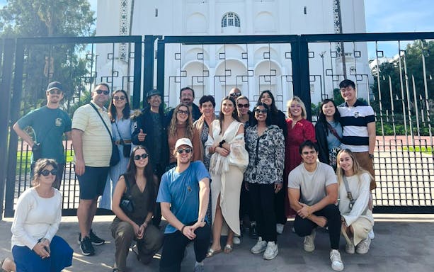 Group of tourists in front of a historic building gate during a Casablanca tour.