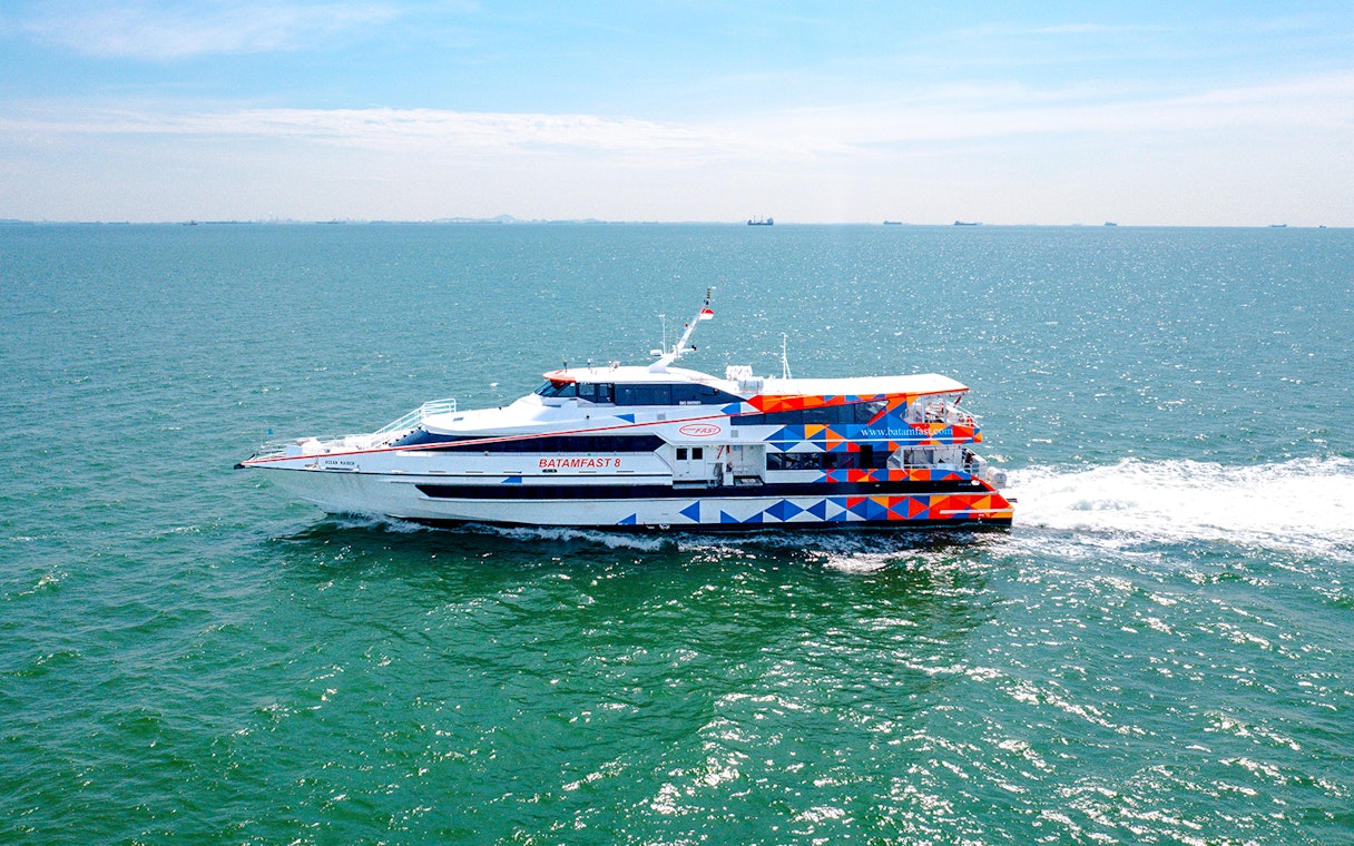 Ferry traveling from Singapore to Batam across the sea.