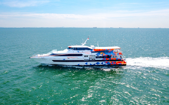 Ferry traveling from Singapore to Batam across the sea.