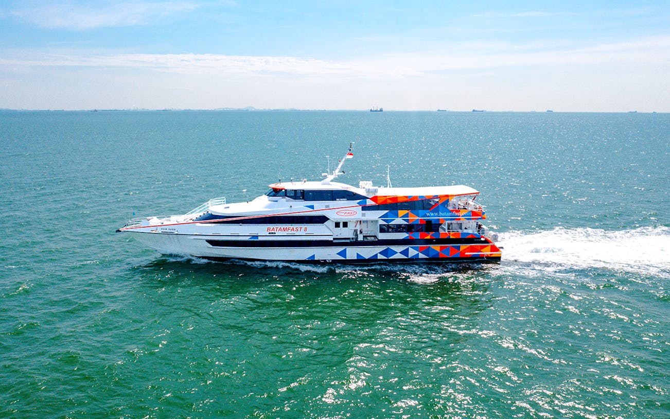 Ferry traveling from Singapore to Batam across the sea.