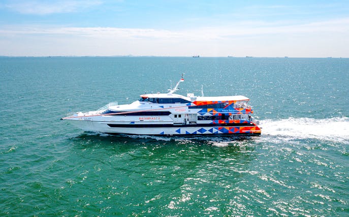 Ferry traveling from Singapore to Batam across the sea.