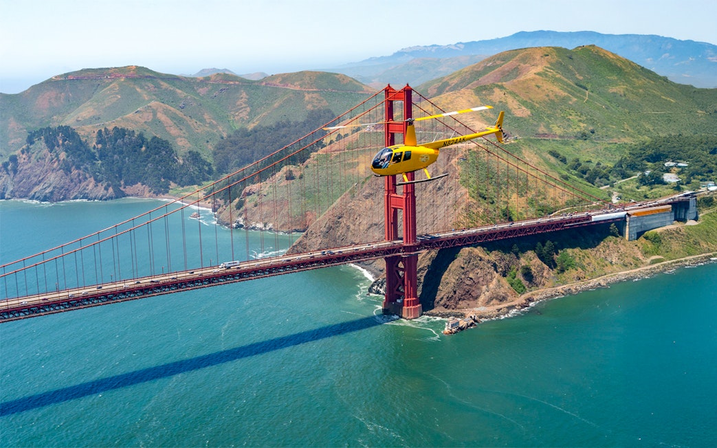 Helicopter flying near the Golden Gate Bridge during a San Francisco tour.