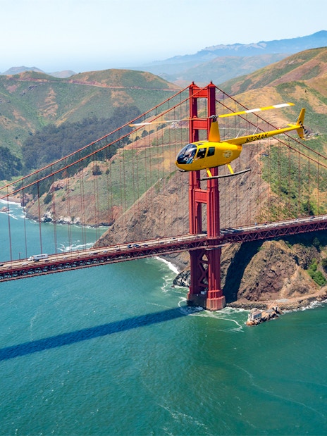 Helicopter flying near the Golden Gate Bridge during a San Francisco tour.