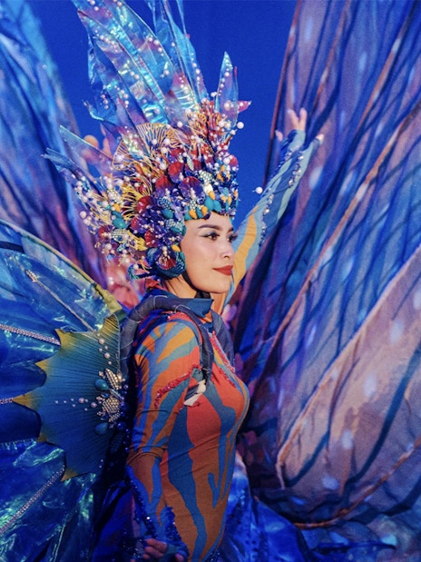Performer in vibrant costume at Varuna Underwater Show, Bali Safari & Marine Park.
