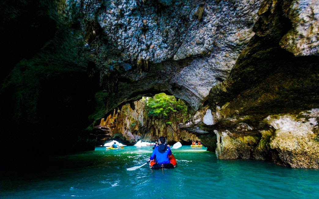 Kayaking through limestone caves in Phang Nga Bay, Thailand.