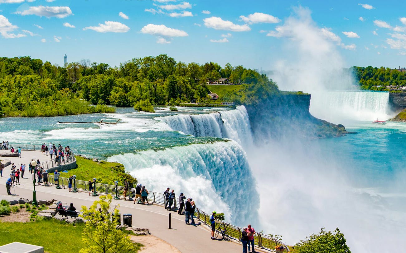 Visitors viewing Niagara Falls from the USA side during an evening tour.