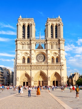 Notre Dame Cathedral facade with visitors in Paris, France.