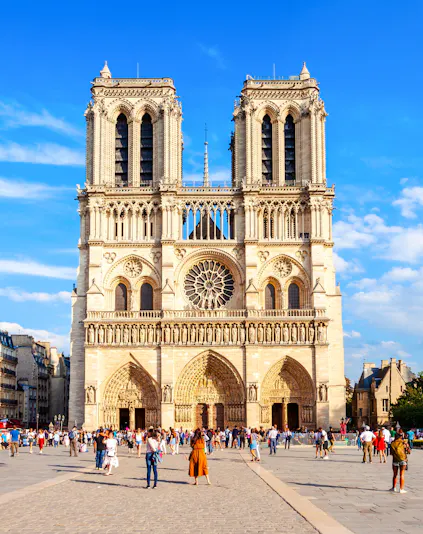 Notre Dame Cathedral facade with visitors in Paris, France.