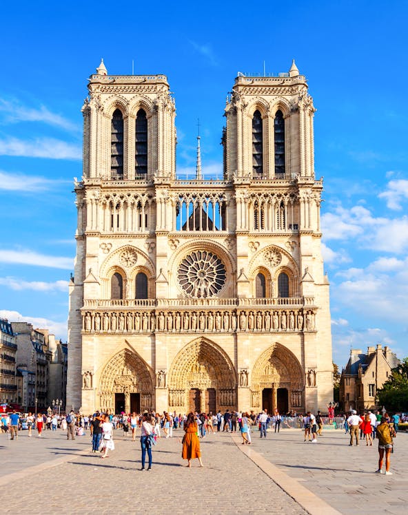 Notre Dame Cathedral facade with visitors in Paris, France.