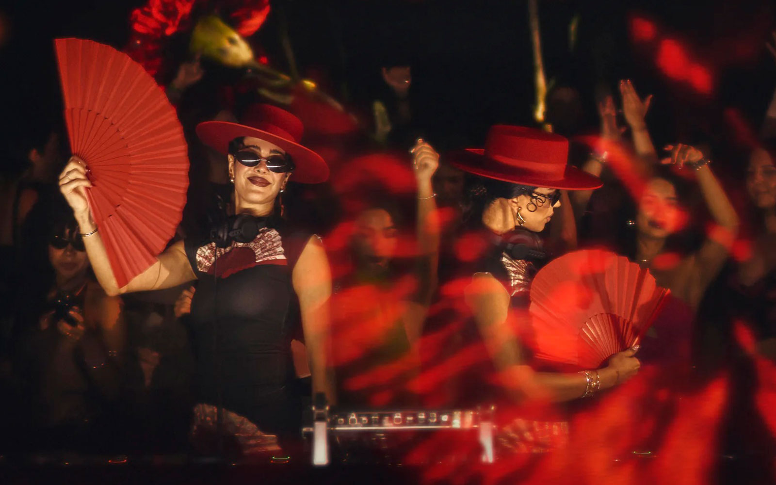 Dancers with red fans and hats performing at Mestiza, Ibiza nightclub.