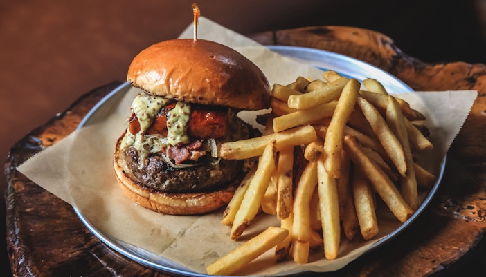 A picture of a burger with fries