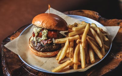 A picture of a burger with fries