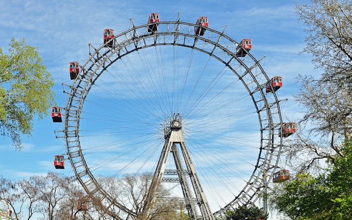Tourists on the Giant Ferris Wheel in Vienna, part of the Hop-On Hop-Off Bus Tour package.